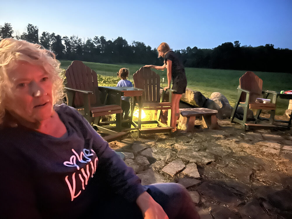 Friends around the campfire after dark