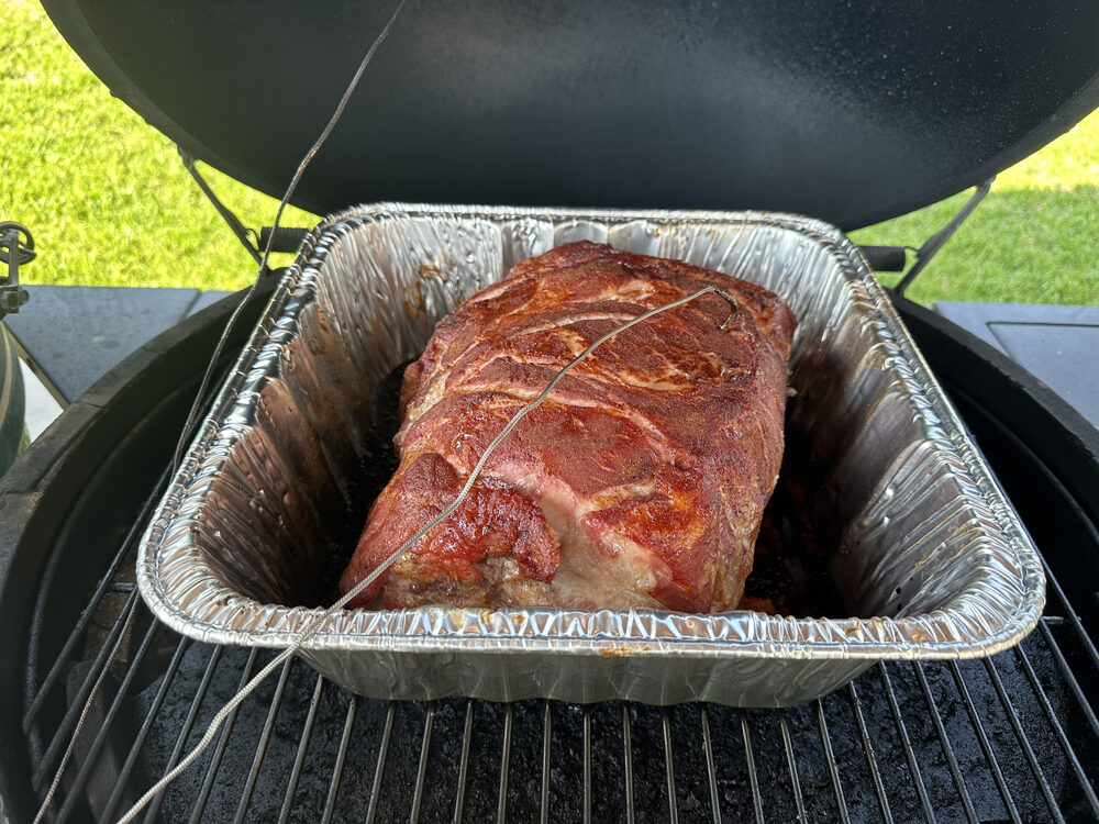 A large roast in a pan on the grill