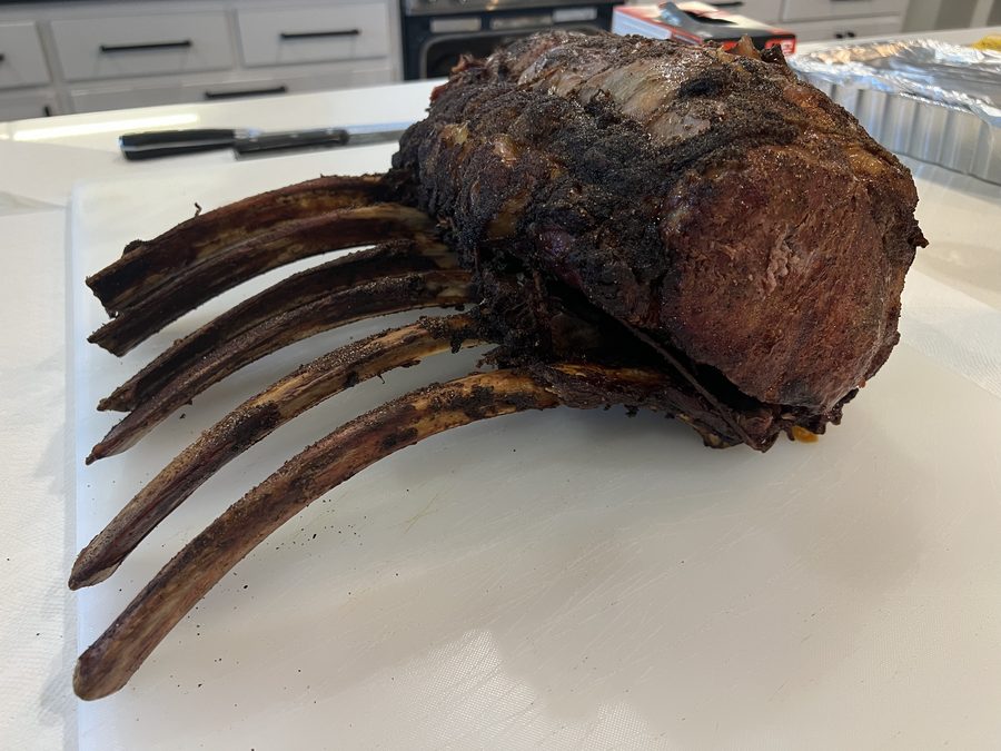 Smoked prime rib resting on a board